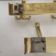 Three vintage 1960s gold coat racks with 4, 3 and 2 hooks