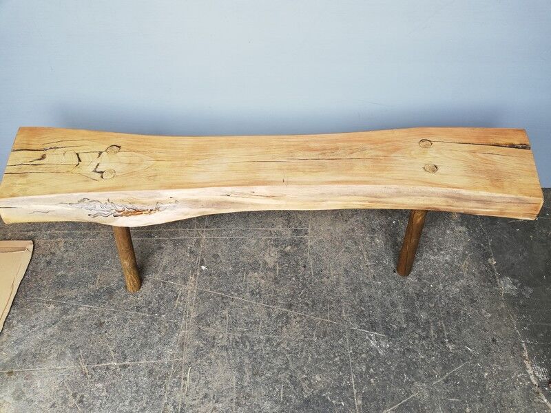Big bench in solid rough wood very thick Brutalism