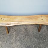 Big bench in solid rough wood very thick Brutalism