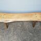 Big bench in solid rough wood very thick Brutalism