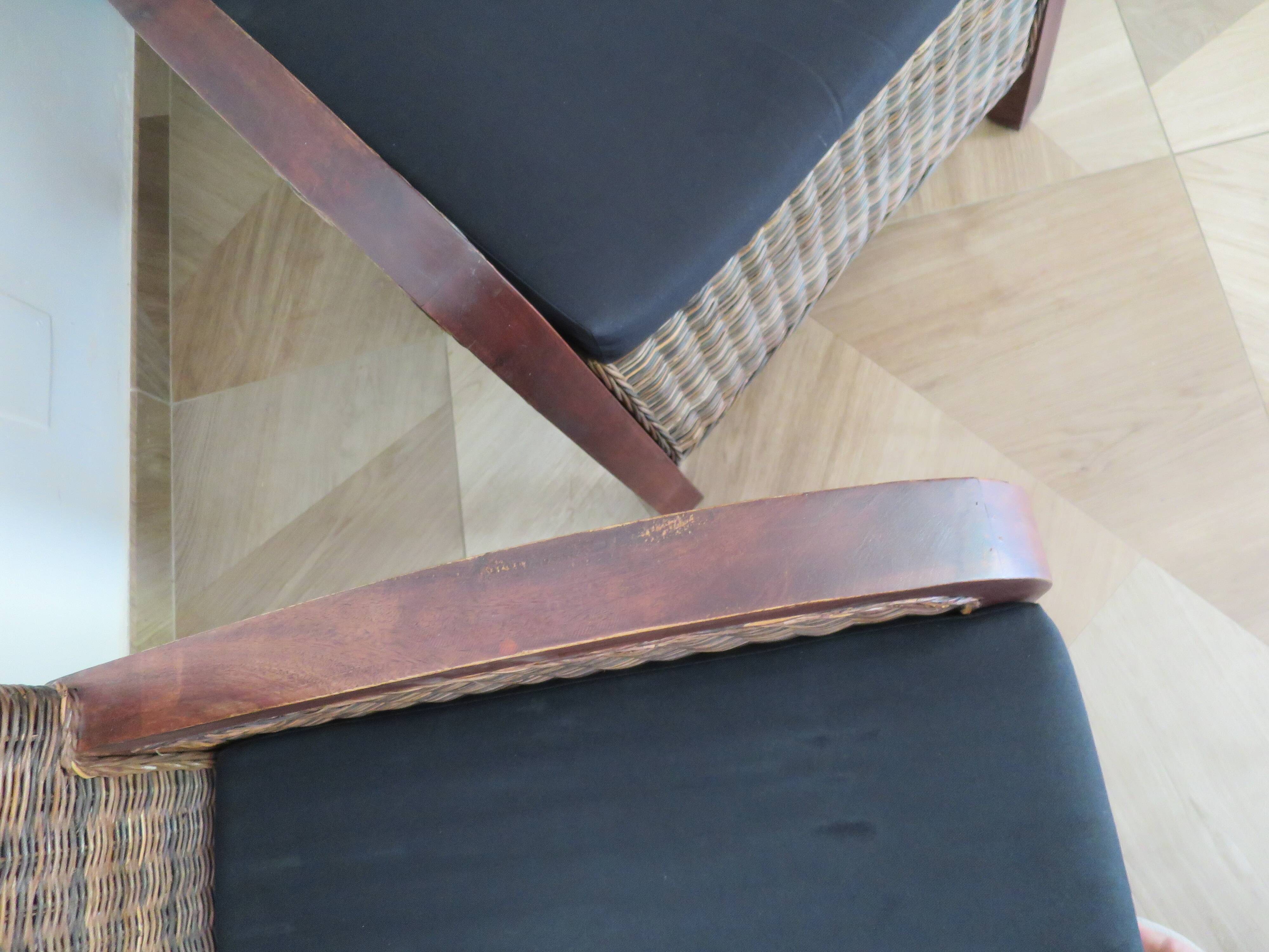 2 colonial-style armchairs in woven rattan and exotic wood