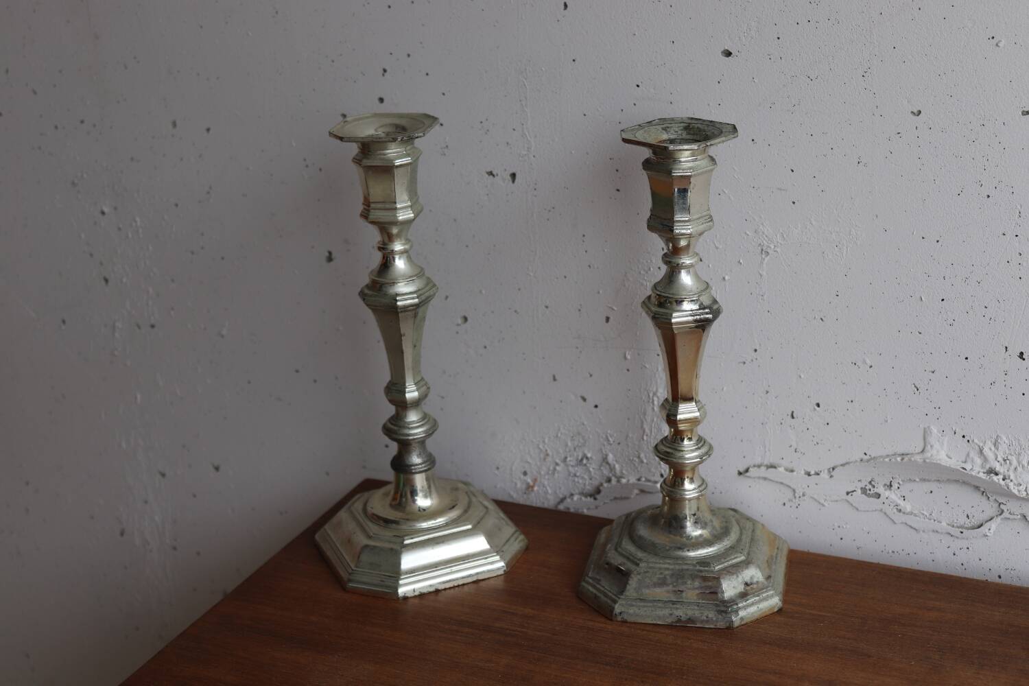 Pair of antique silver-plated metal candlesticks