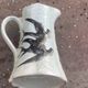 Jade green ceramic barbotine vase with swallows.