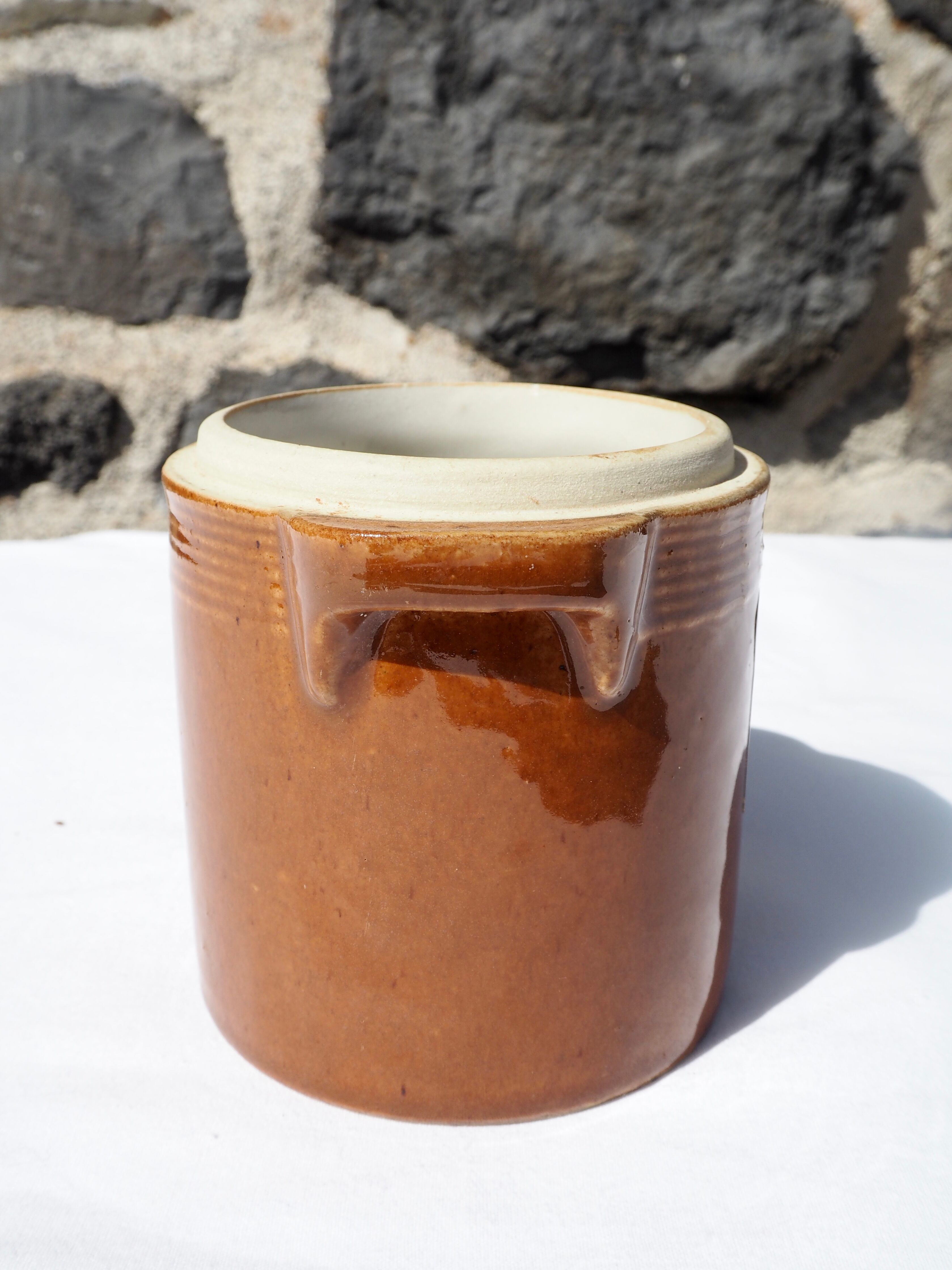 Trio of stoneware pots with lids