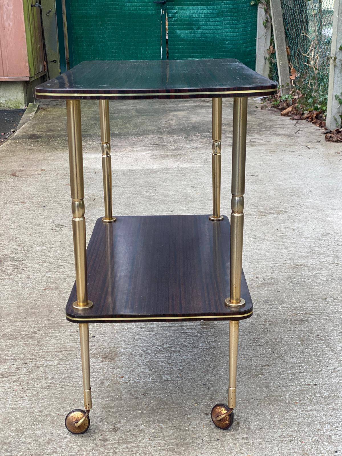 Brown rosewood rolling table with gold legs