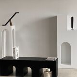 Black solid monoxyl wood bench carved into 3 arches