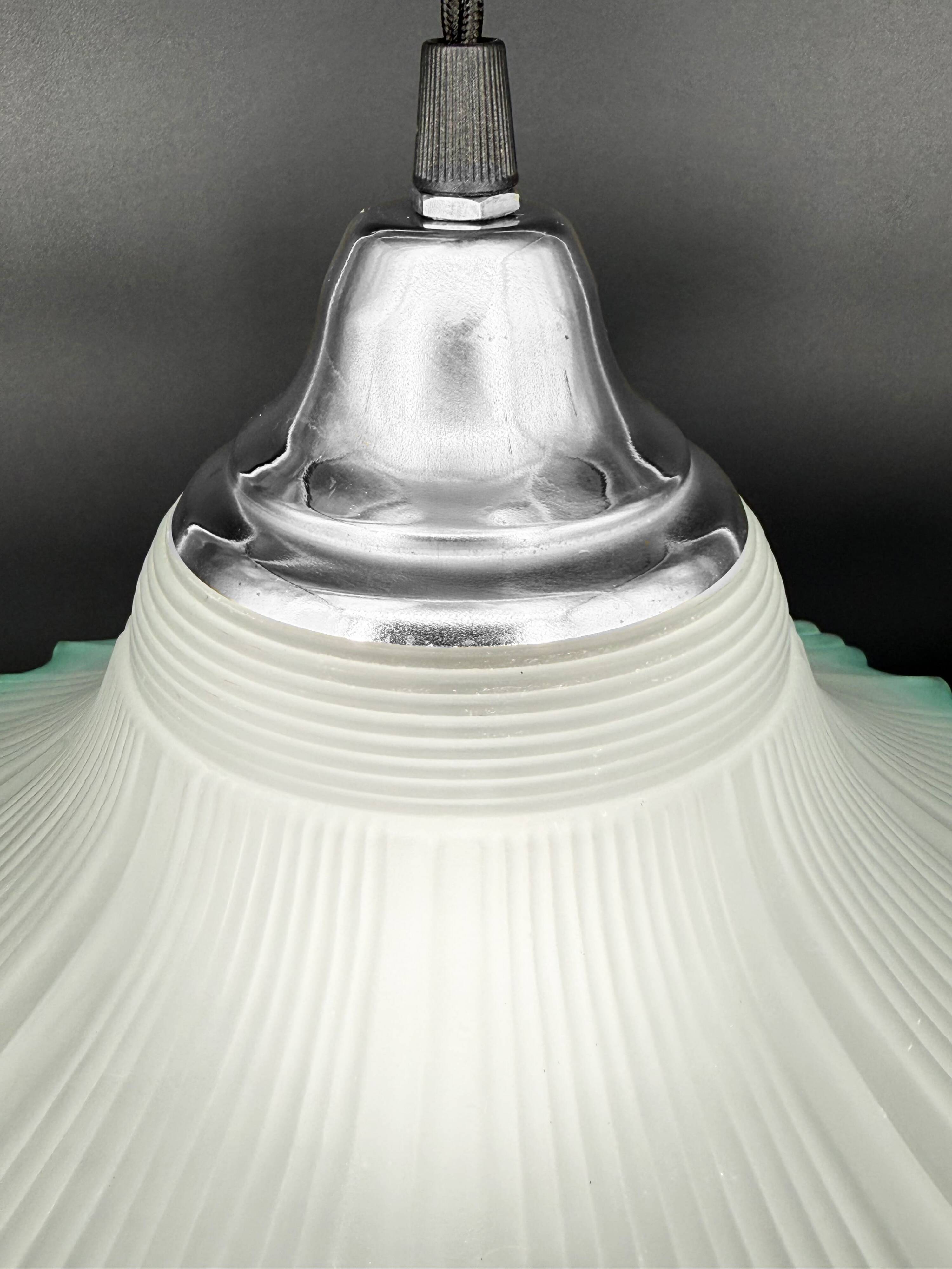 Frosted glass flower pendant with a water green edge.