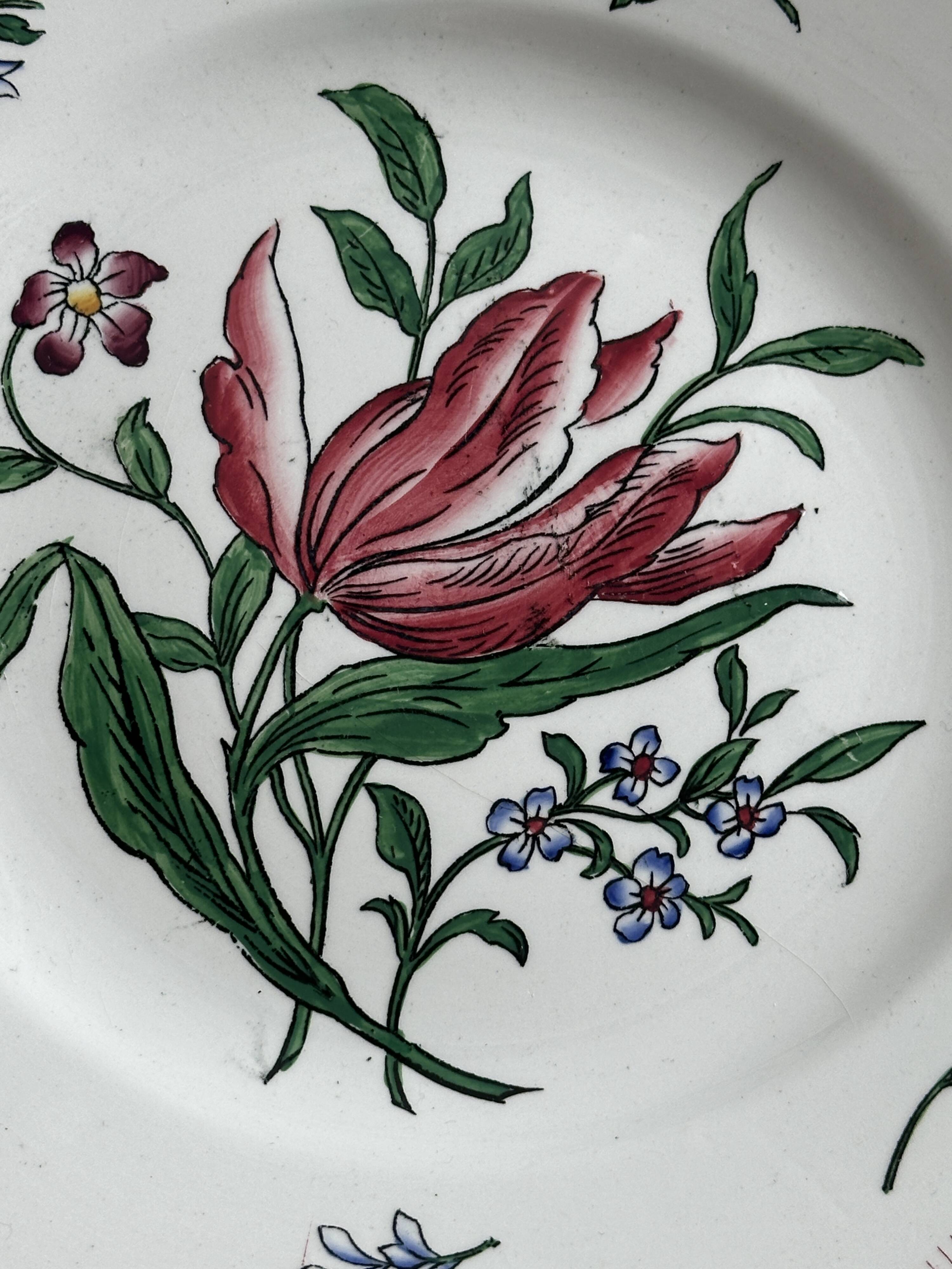 5 plates with colorful Sarreguemines floral designs.