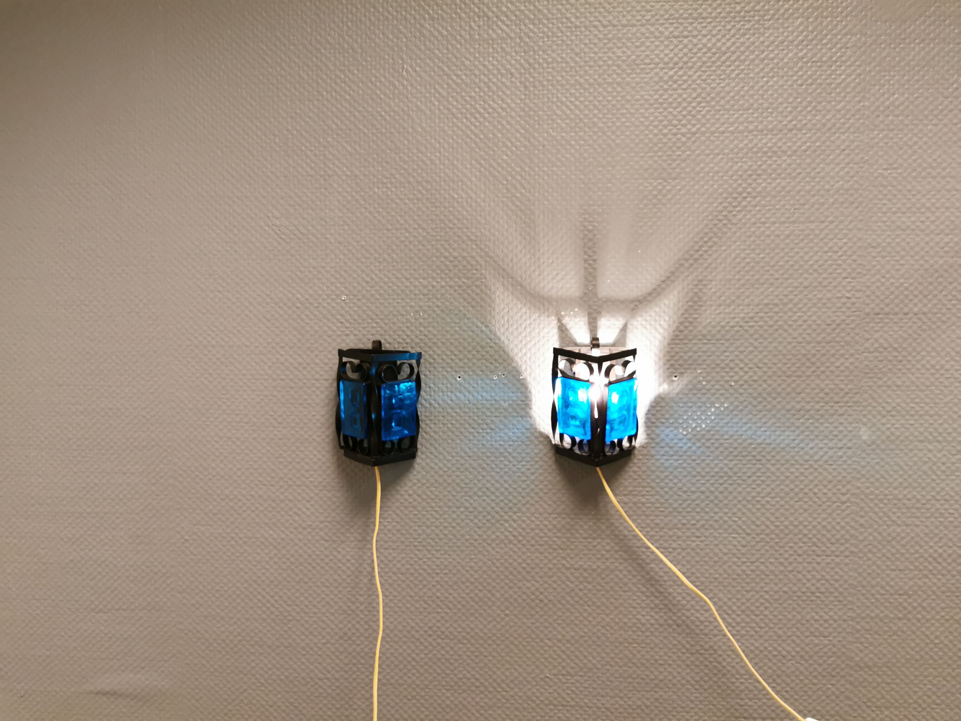 Wall lamps made of black cast iron and handmade thick pressed blue glass