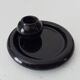 Vintage black ceramic candle holder on a bowl