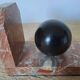Pair of red marble bookends with black stone spheres – Art Style