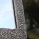 Oriental mirror in chiseled metal – beveled, for placing on a surface or hanging