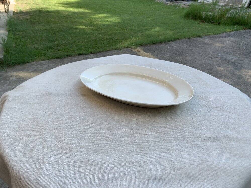 Large oval cream serving platter in ceramic - vintage model from the 1950s, wide rim.