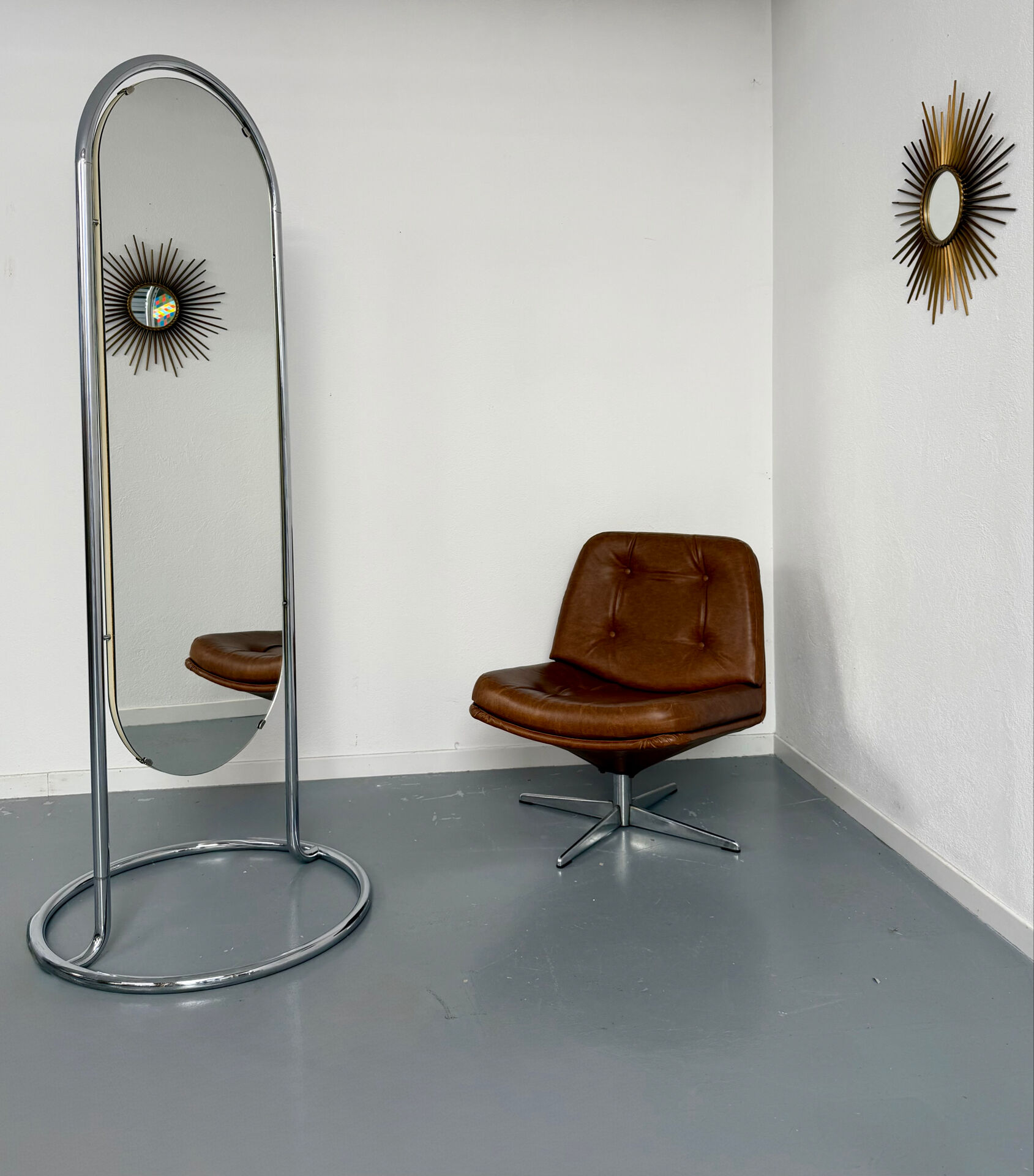 Large freestanding chrome metal full-length mirror in 1970s design.