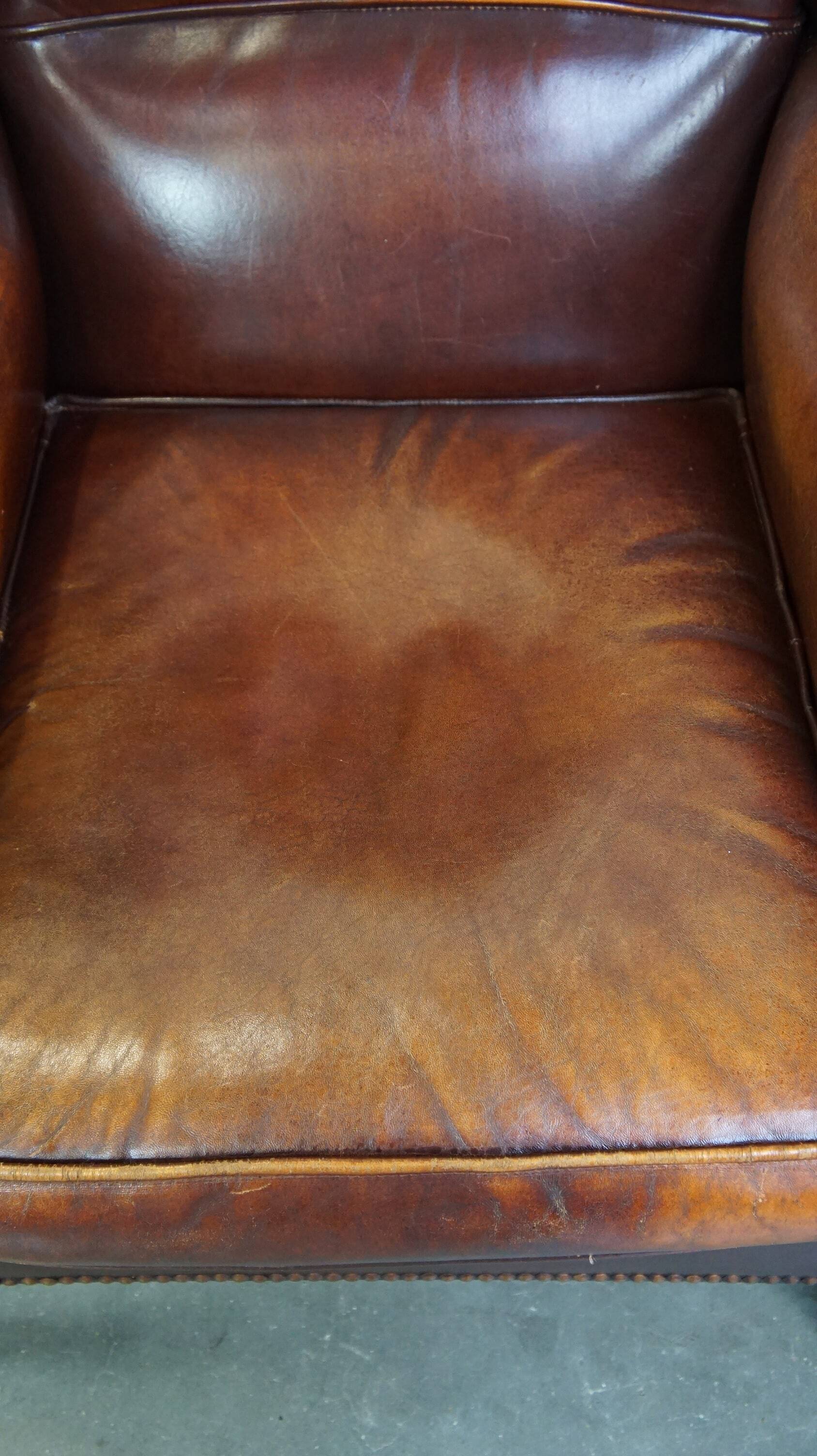 Comfortable, elegant, stately wing chair made of sheepskin in a beautiful warm color