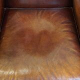 Comfortable, elegant, stately wing chair made of sheepskin in a beautiful warm color