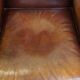 Comfortable, elegant, stately wing chair made of sheepskin in a beautiful warm color