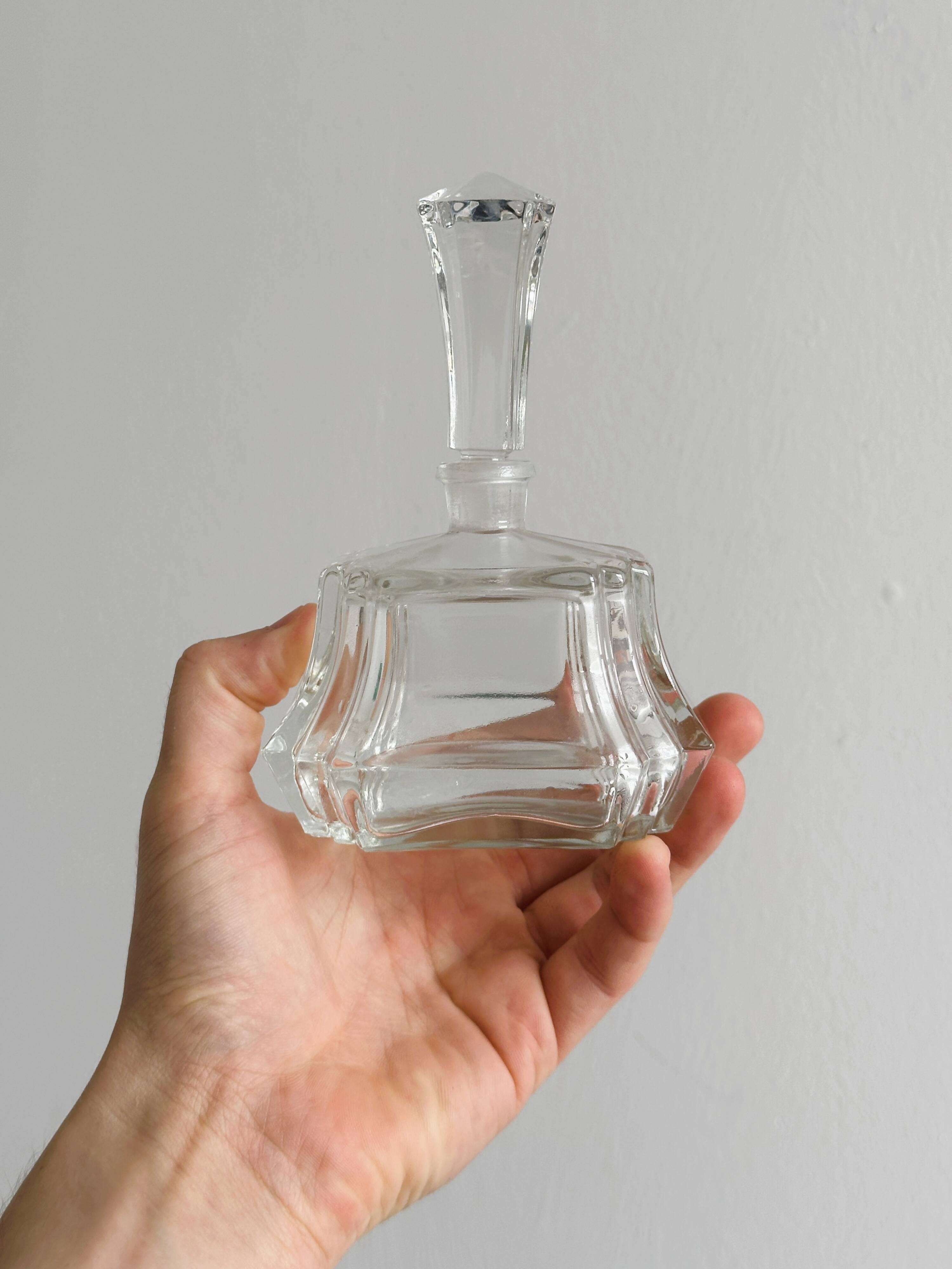 Small transparent faceted glass bottle