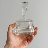 Small transparent faceted glass bottle