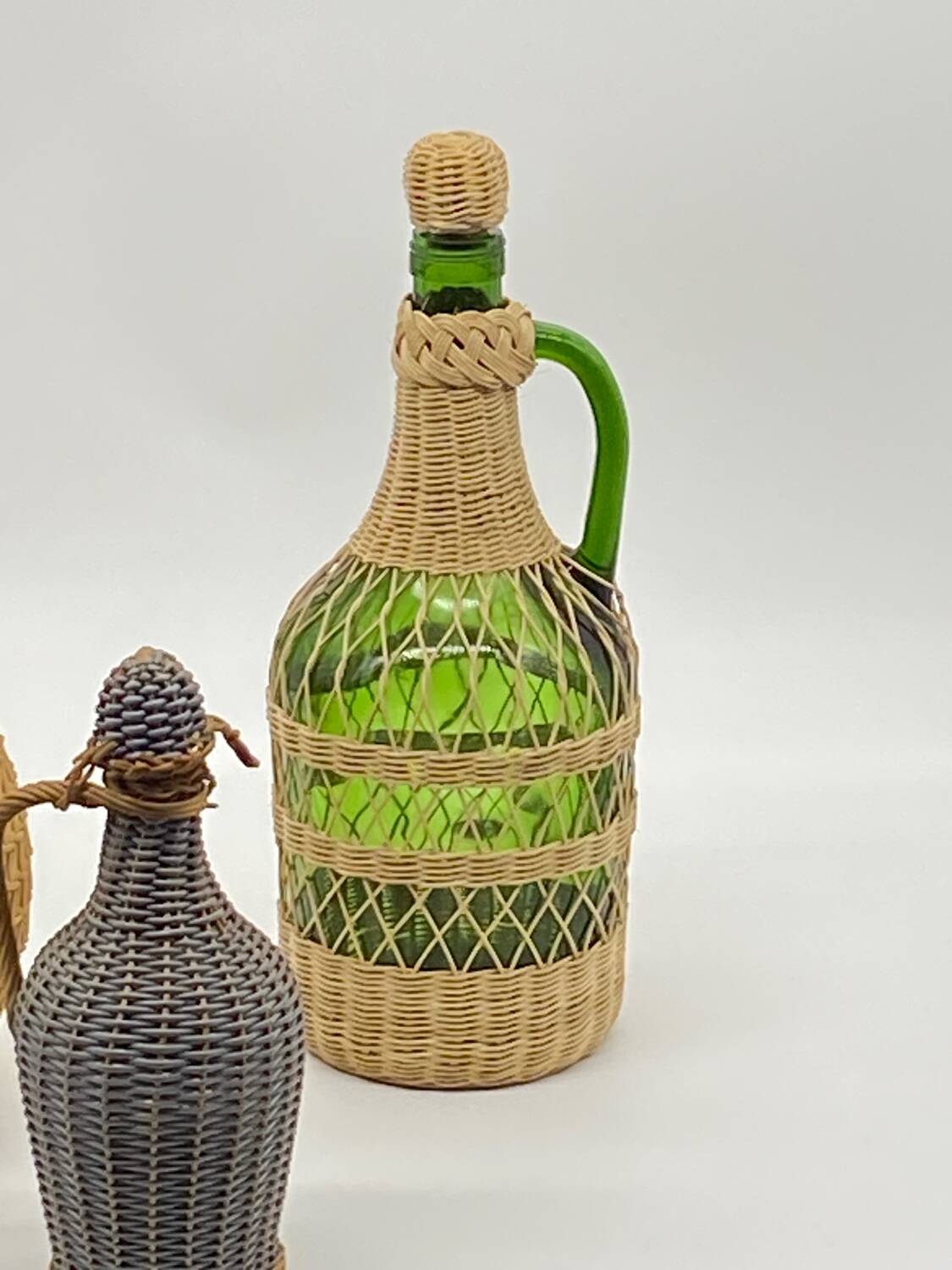 Trio bottles / lady Jeanne, dressed in wicker, rattan, natural fibers