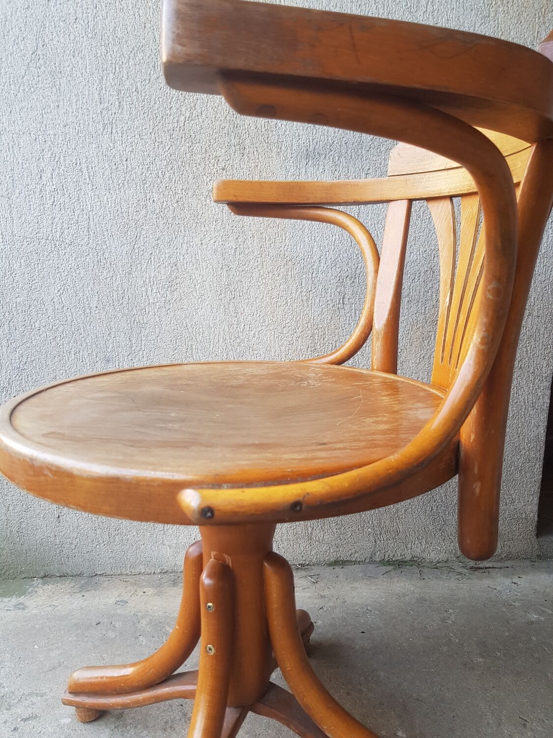 Swivel wooden armchair