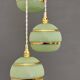 Suspension triple vintage glass globes in frosted green and gold.