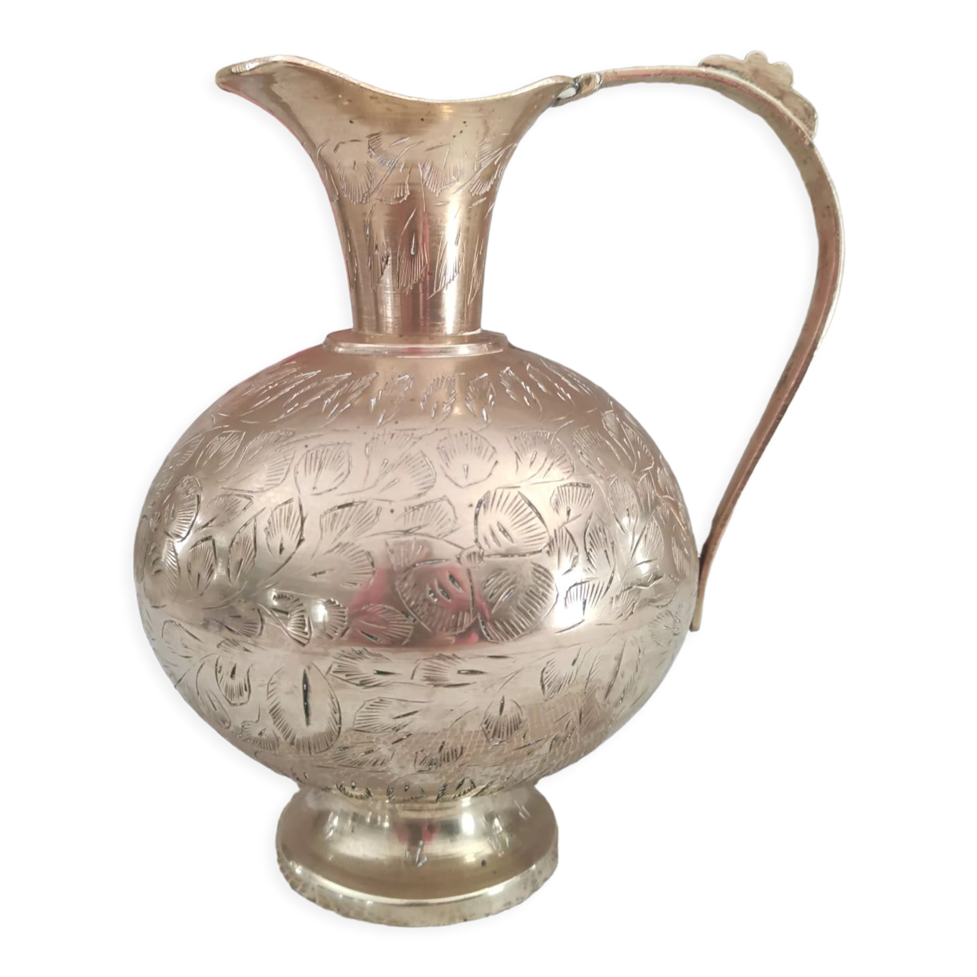 Chiseled brass pitcher decorated foliage