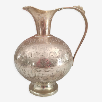 Chiseled brass pitcher decorated foliage