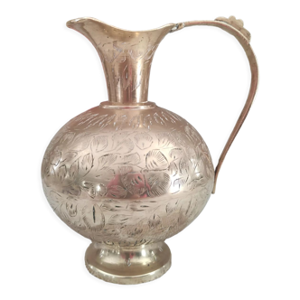 Chiseled brass pitcher decorated foliage