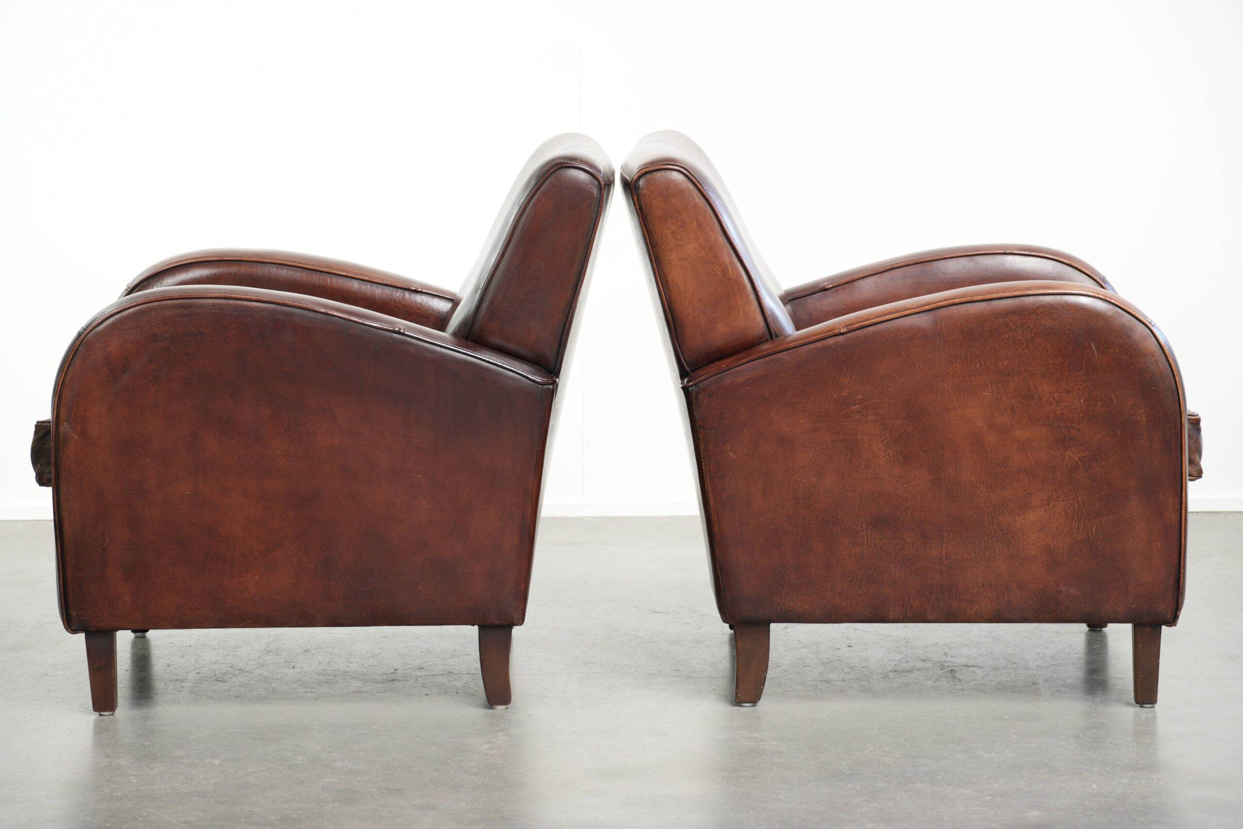 Dark cognac-coloured set of 2 sheepskin armchairs with a sleek design