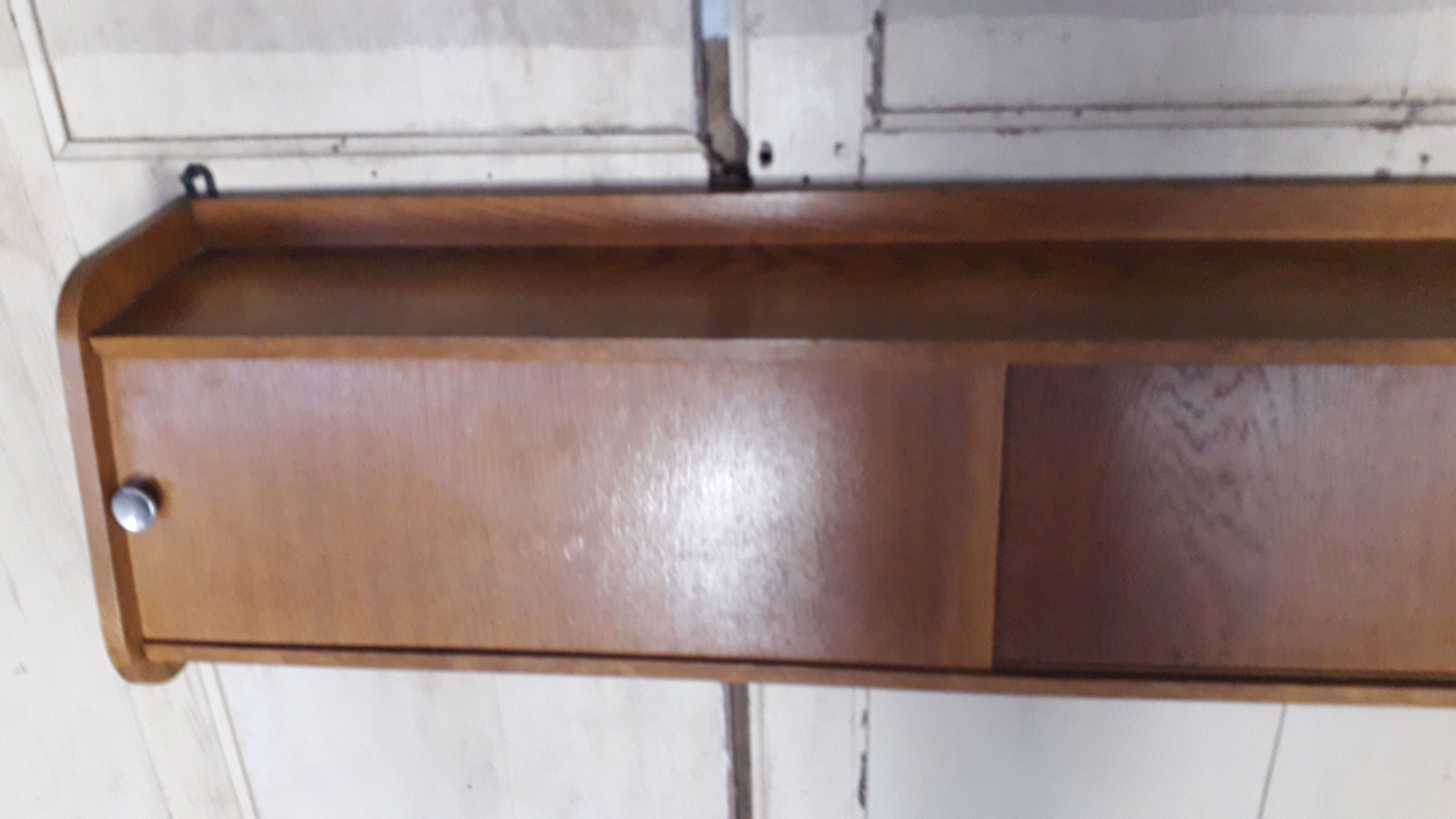 Wall shelf with sliding doors