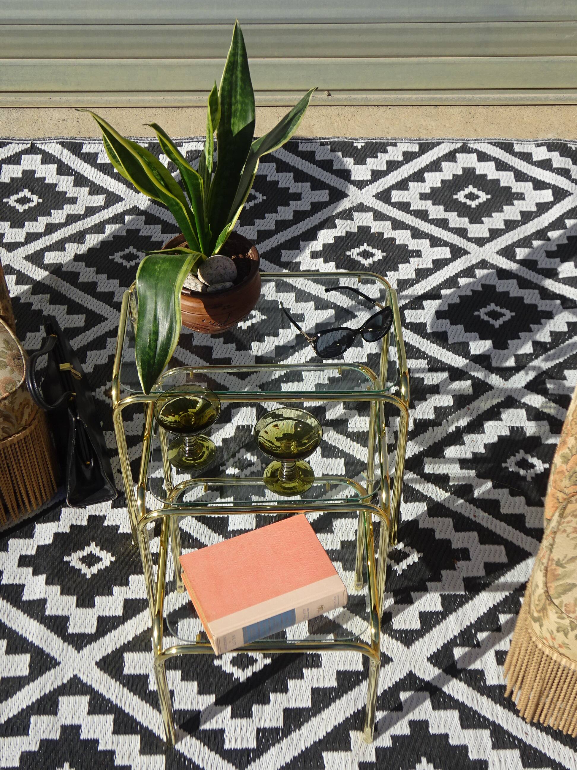 Nesting tables in gold-tone metal and glass