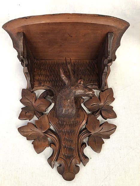 Pair of carved wooden wall consoles decorated with a deer's head