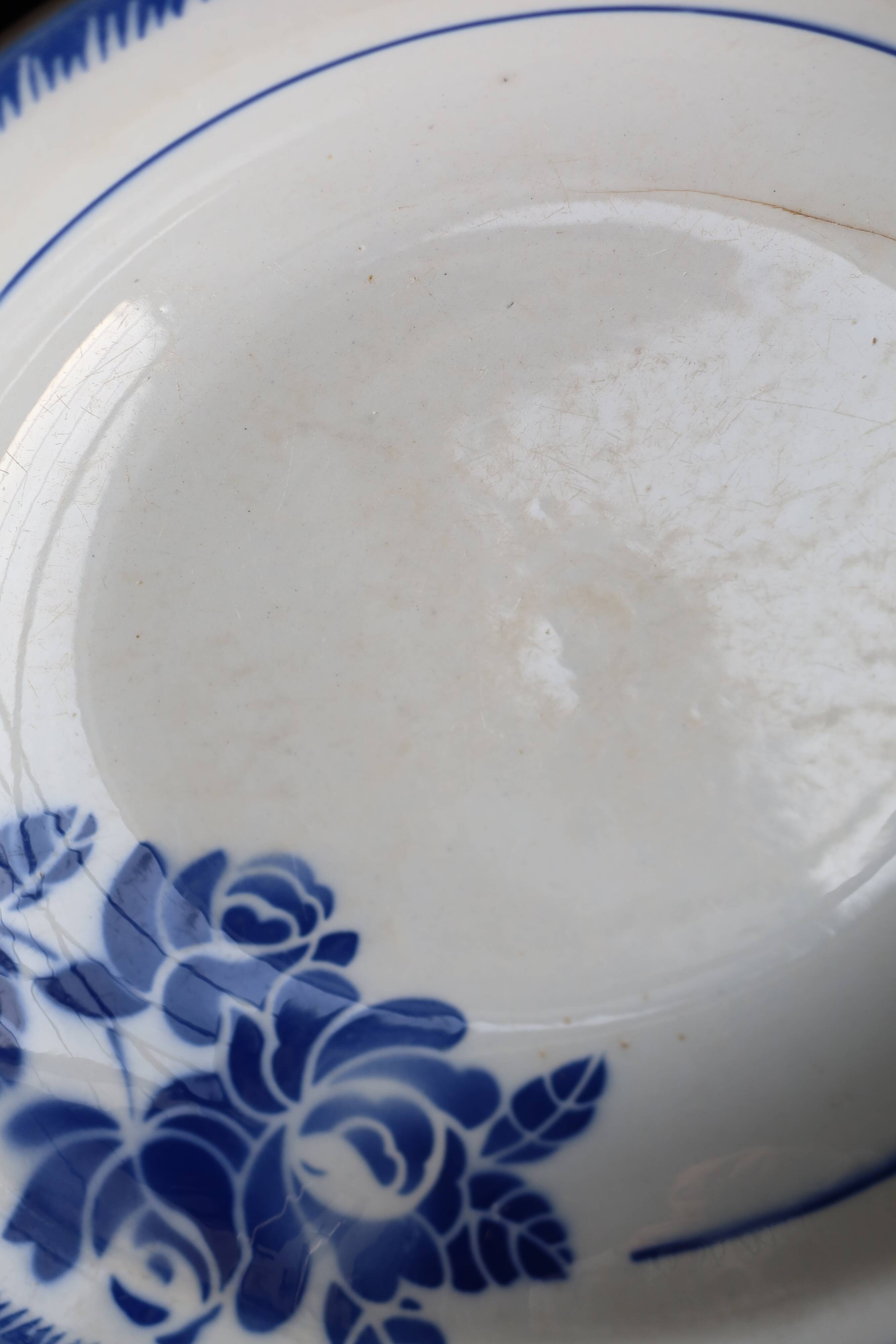 Antique shallow dish from Badonviller with blue flower decoration.