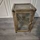 Brown weathered wooden display cabinet with 2 glass shelves.
