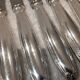 12 silver-plated table knives, Christofle goldsmith ribbons