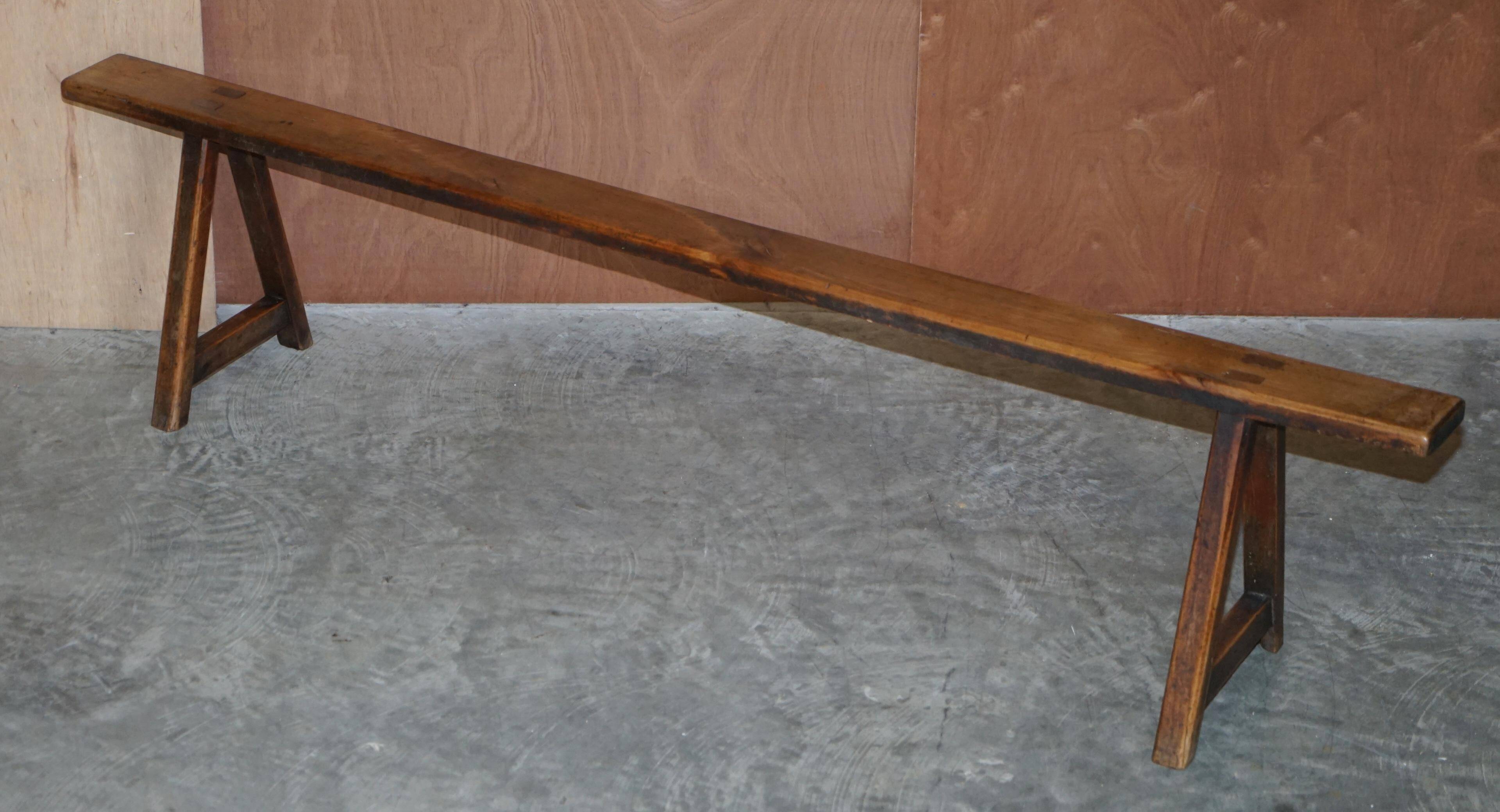 Pair of antique Victorian trestle benches in fruitwood.