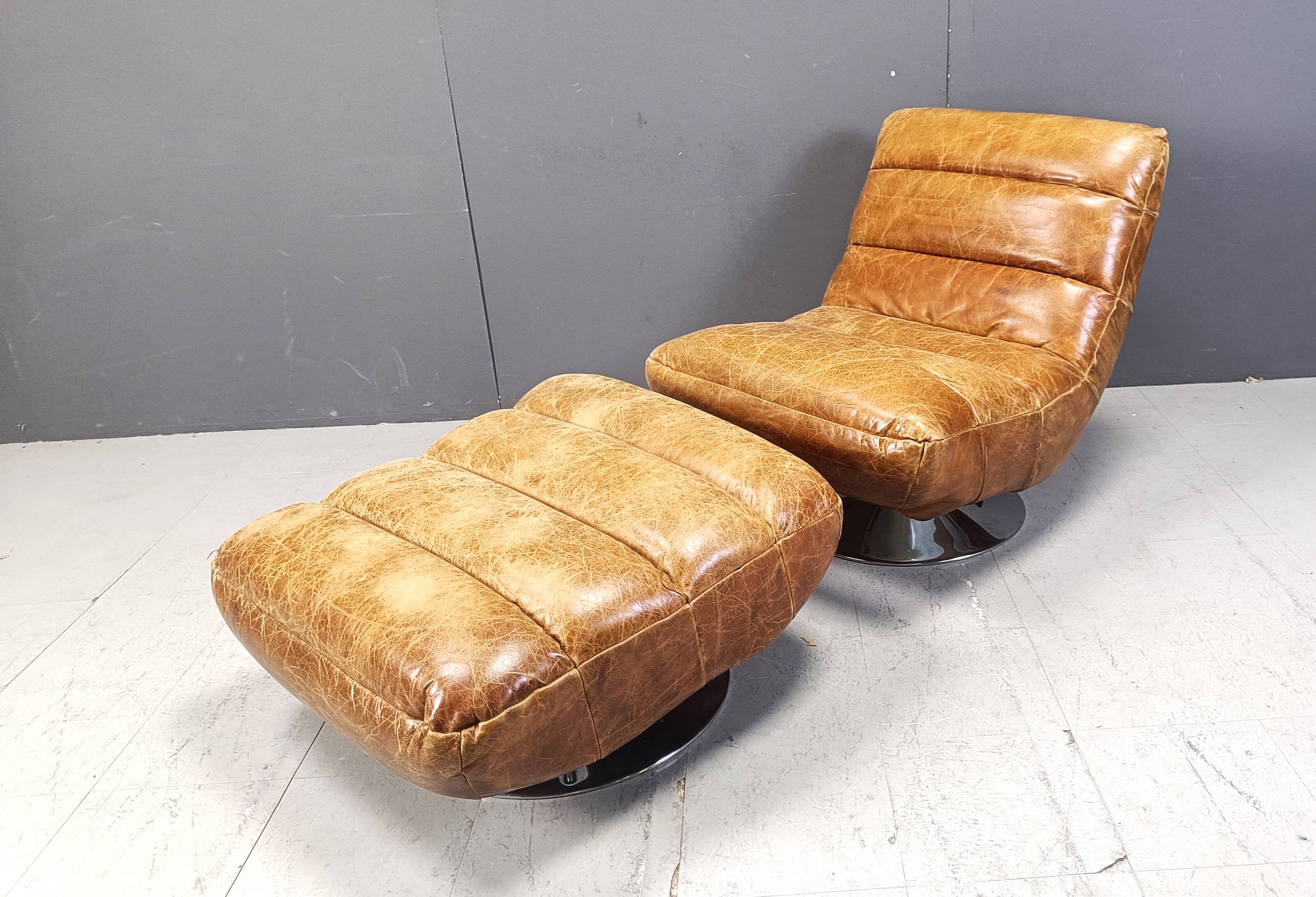 Vintage leather swivel chair with stool, 1970s