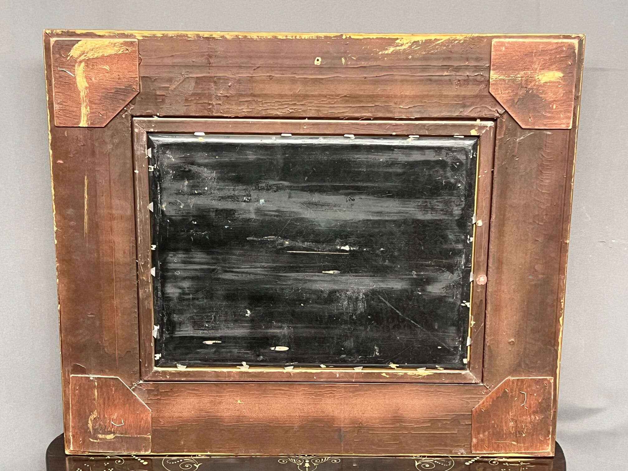 Still life with roses in a beautiful frame on a wooden panel in Flemish style.