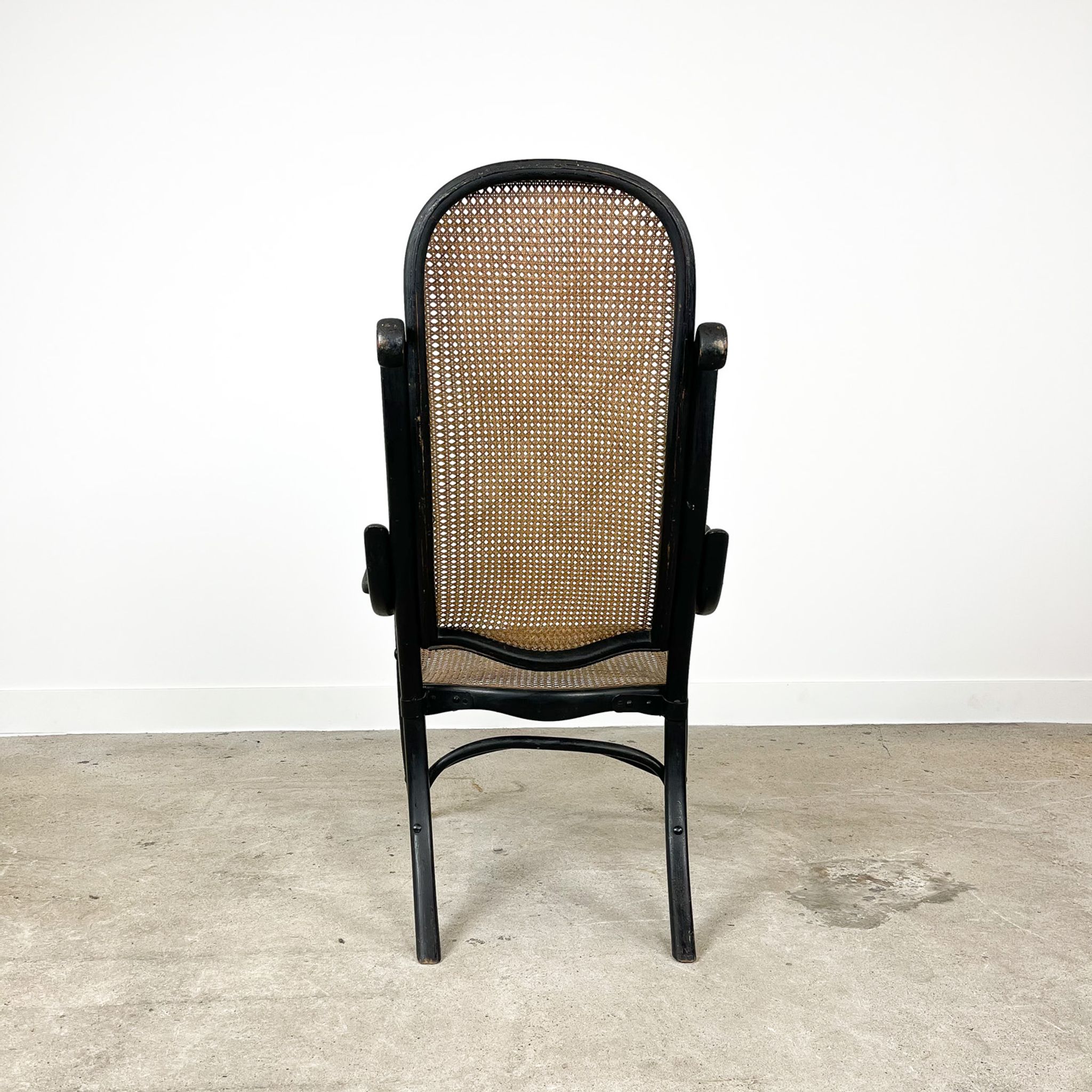 Antique black bentwood and cane lounge armchair by Thonet 19th century