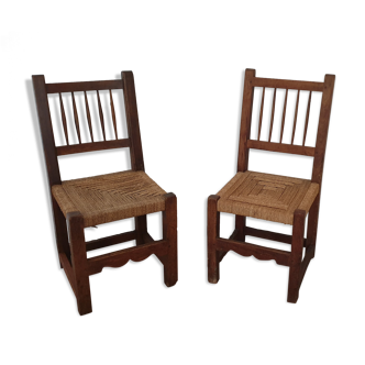 Old pair of wooden chairs and rope