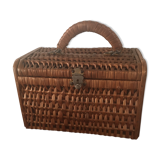 Bagged suitcase in braided wicker and wood