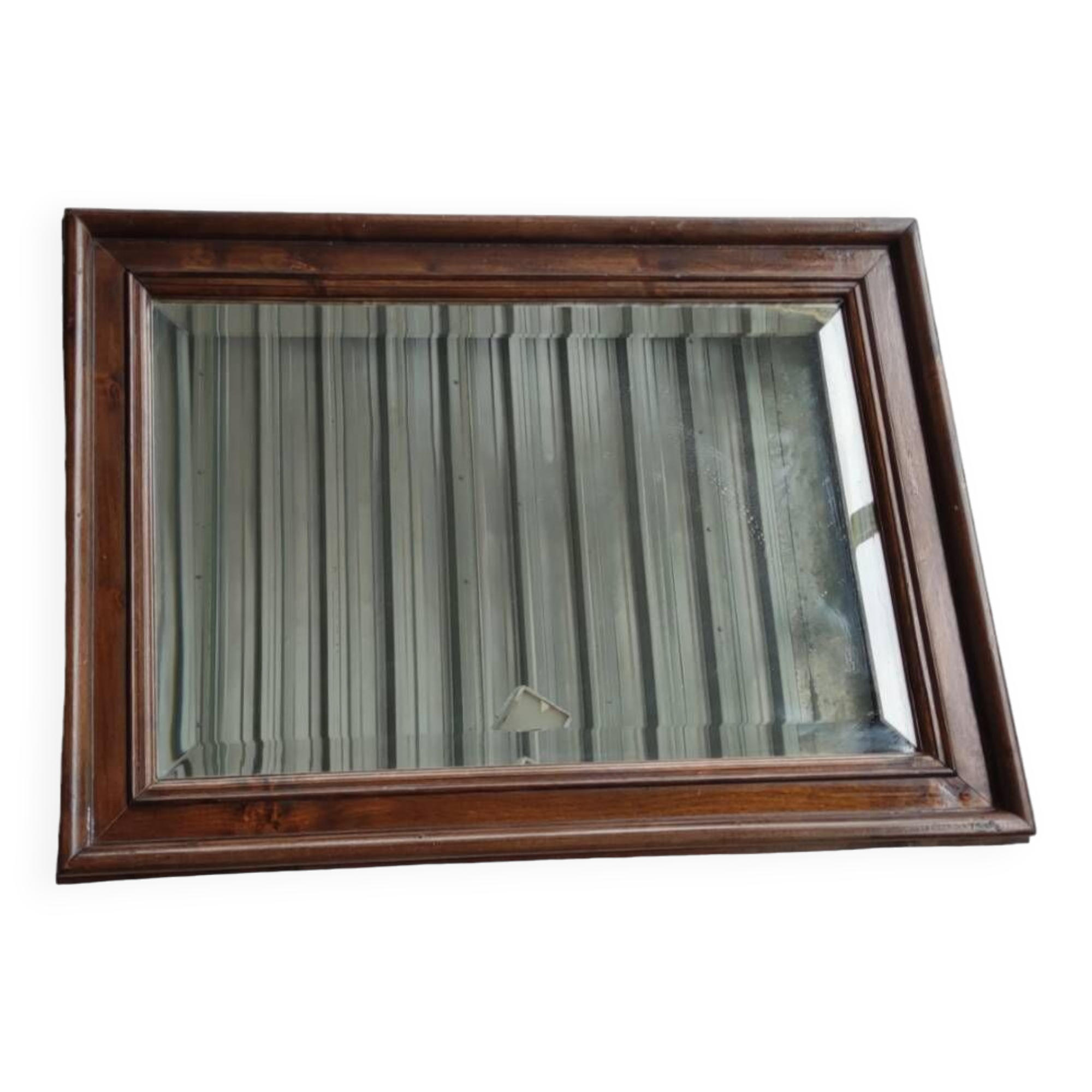 Old beveled mirror with wooden frame
