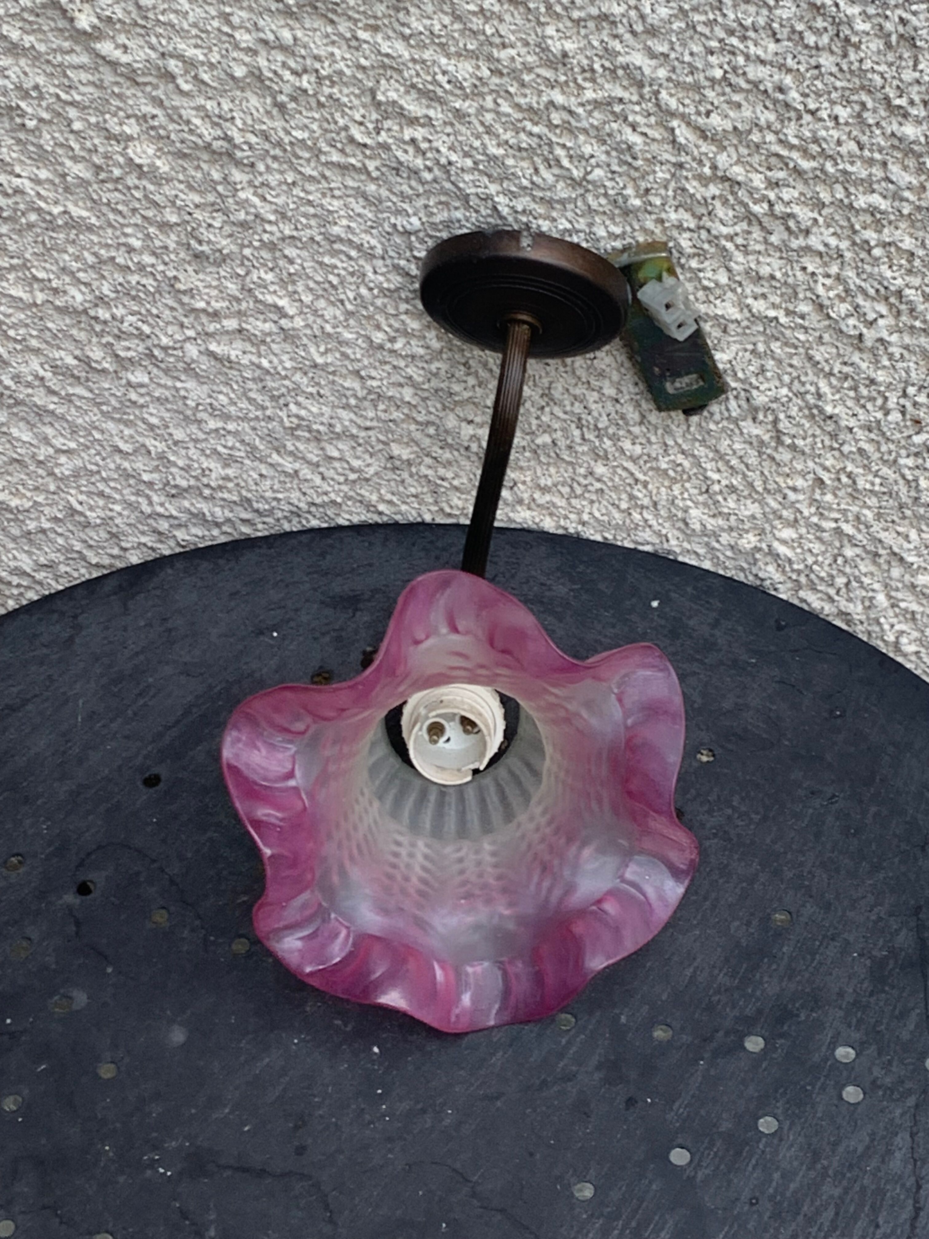 Metal wall lamp with frosted glass shade in the shape of a pink corolla