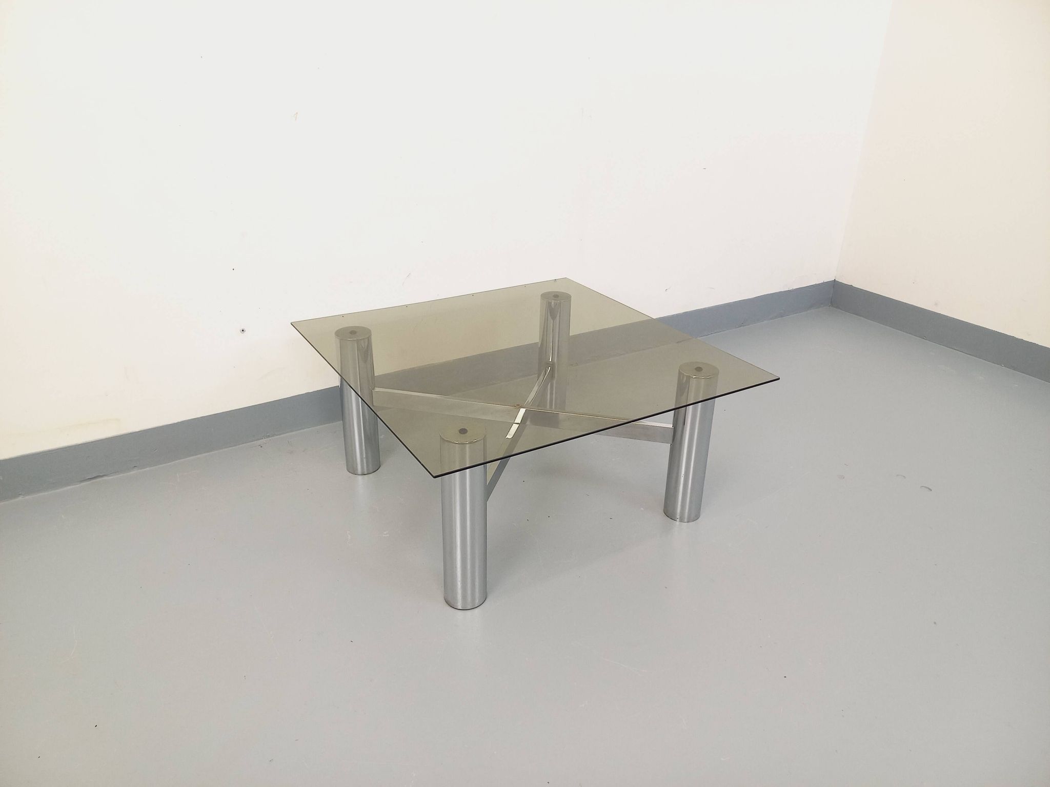 Square Italian vintage Space Age coffee table in smoked glass and metal.