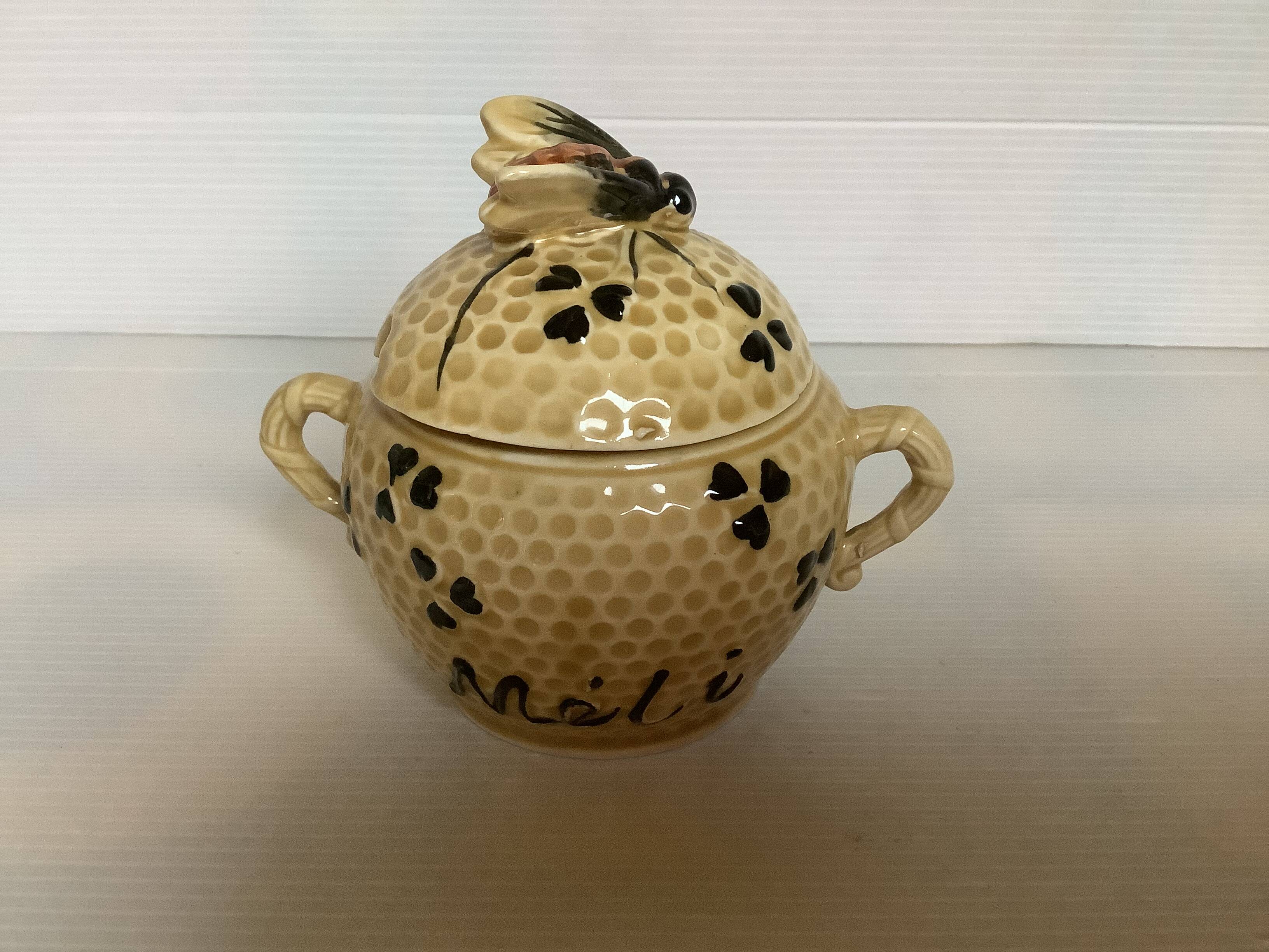 Old honey pot with bee decoration