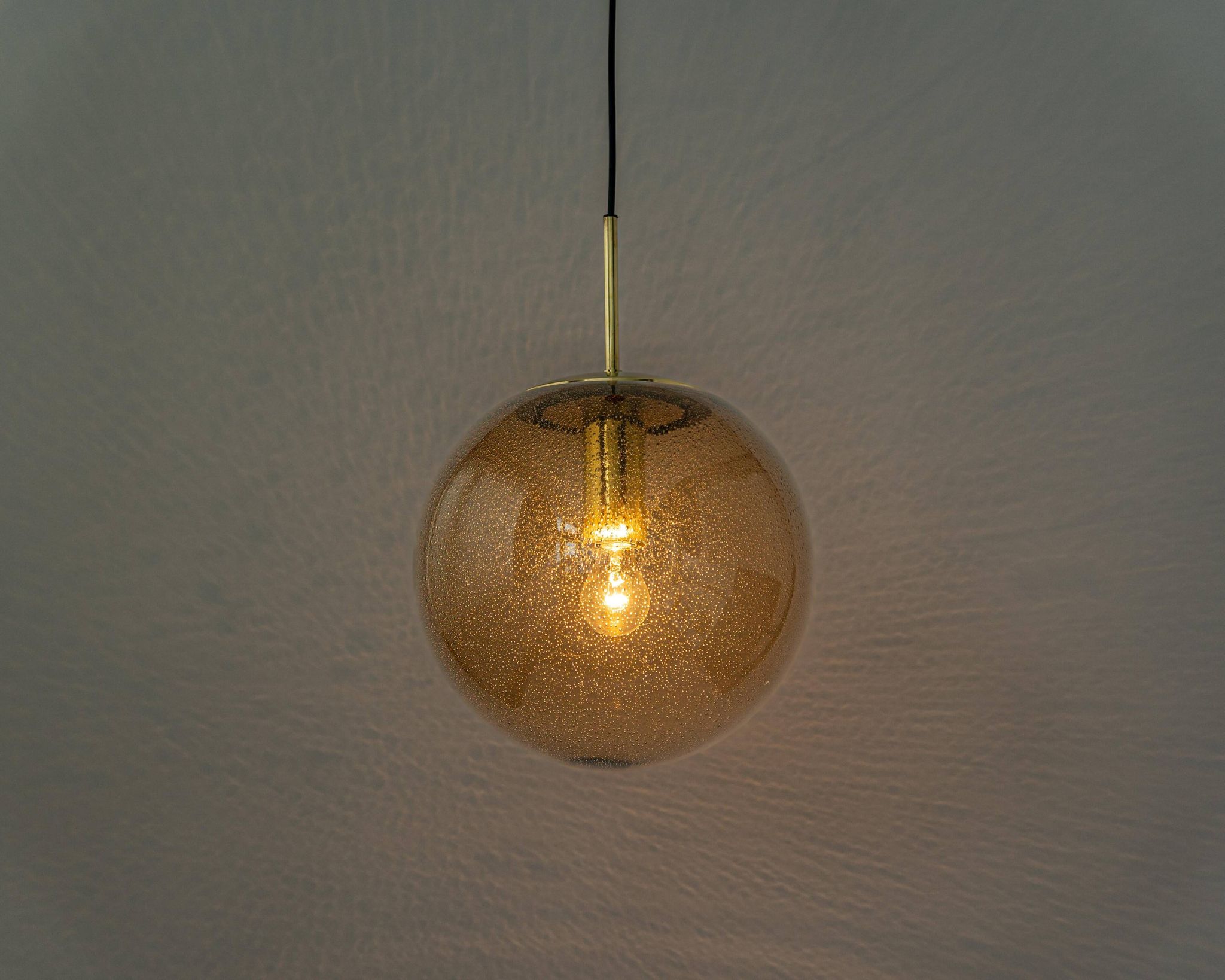 Large smoked glass ball pendant by Limburg with brass, Germany, 1970s.