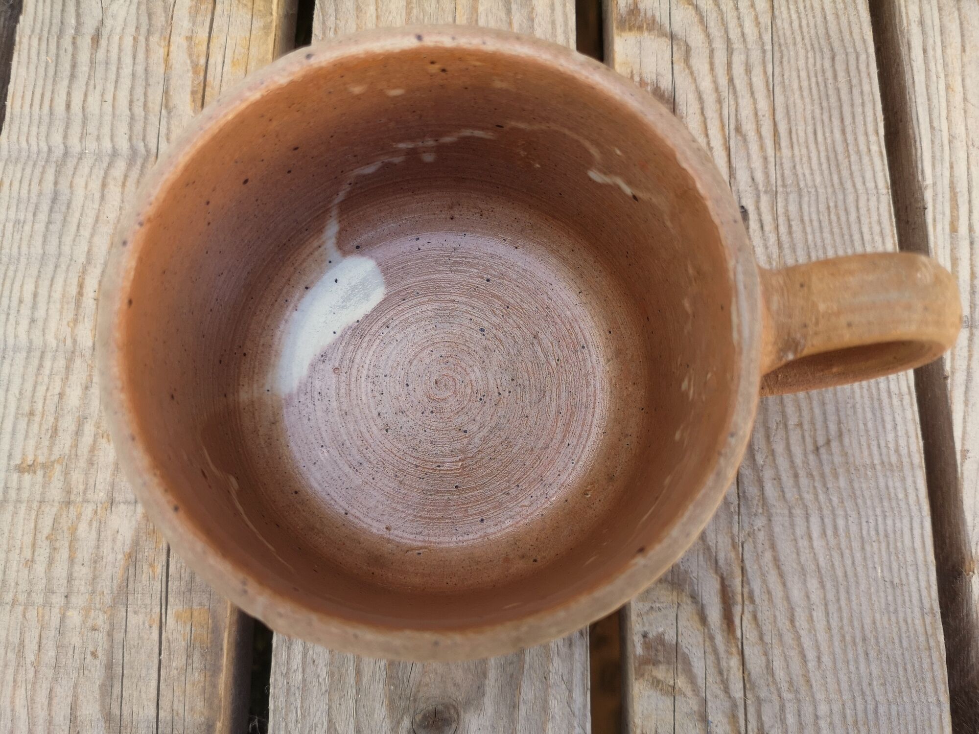 Brown sandstone cup with white spots