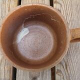 Brown sandstone cup with white spots