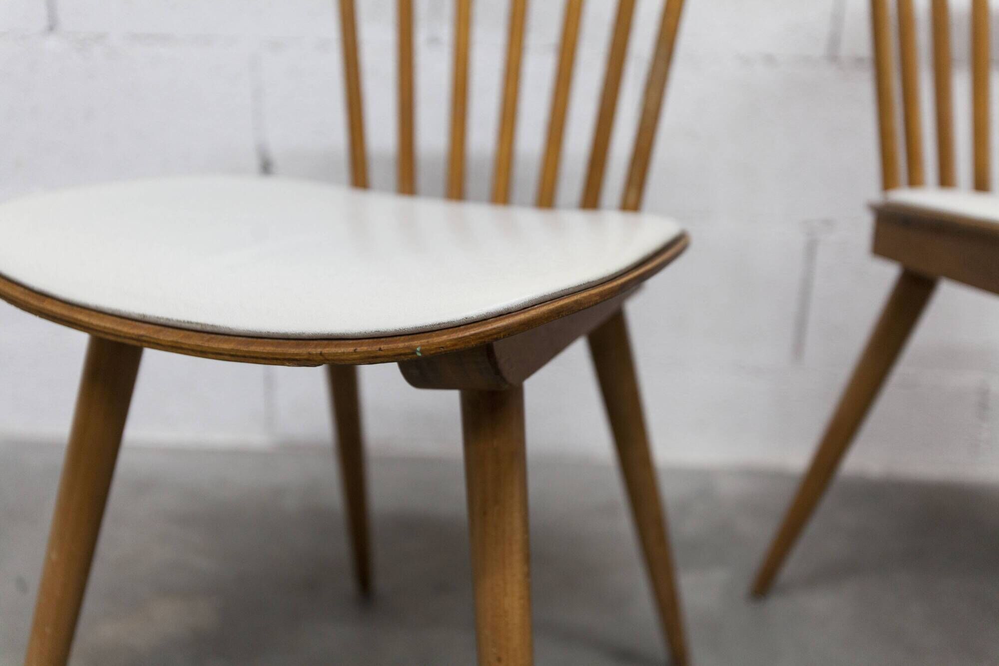 Pair of Baumann Menuet chairs, Honey patina, White skai seat